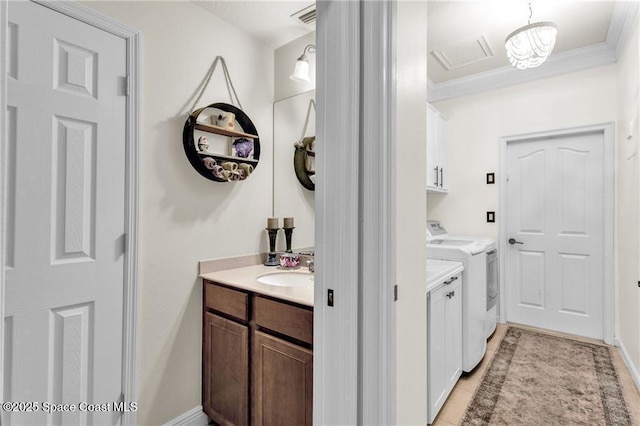 121 Amherst Ln, Sebastian, FL 32958 - laundry area with cabinet space, washer and clothes dryer, crown molding, and light tile patterned floors