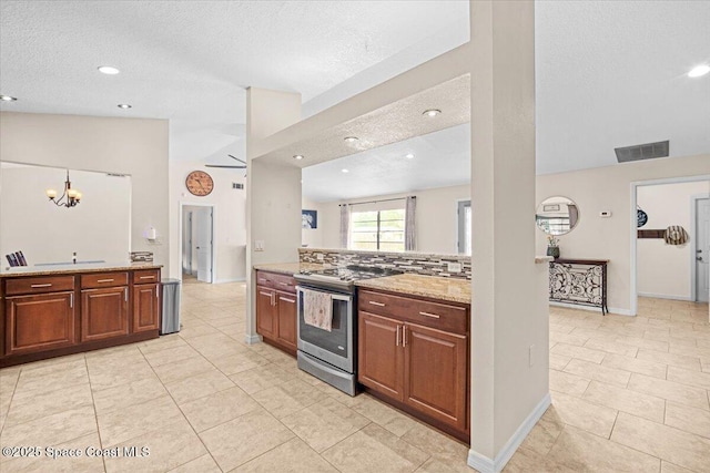 7020 Kaylor Ave, Cocoa, FL 32927 - kitchen with stainless steel electric stove, a textured ceiling, light tile patterned flooring, light stone counters, and a chandelier