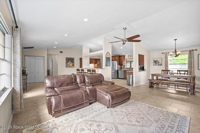 7020 Kaylor Ave, Cocoa, FL 32927 - living room featuring lofted ceiling, a ceiling fan, a chandelier, and recessed lighting