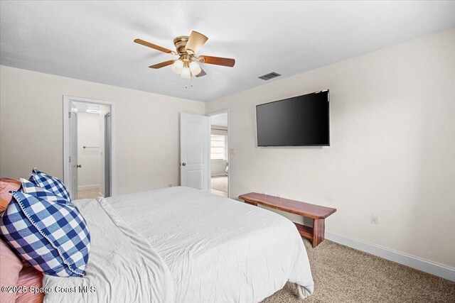 7020 Kaylor Ave, Cocoa, FL 32927 - bedroom featuring light carpet, a ceiling fan, and ensuite bathroom
