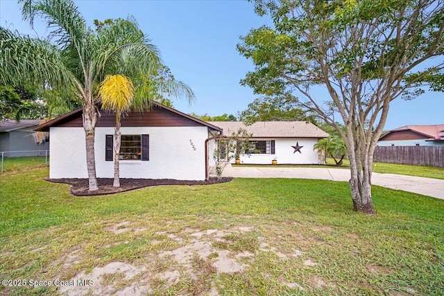 7020 Kaylor Ave, Cocoa, FL 32927 - view of front of house with stucco siding and curved driveway