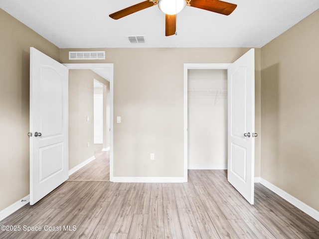 999 Zambrana St SE, Palm Bay, FL 32909 - unfurnished bedroom with light wood-style floors, a closet, and baseboards