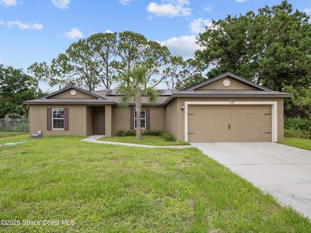 999 Zambrana St SE, Palm Bay, FL 32909 - single story home with stucco siding, roof mounted solar panels, an attached garage, and driveway