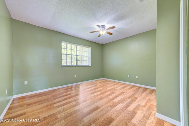4956 Corfu Dr, Cocoa, FL 32926 - empty room featuring ceiling fan, light wood-type flooring, a textured ceiling, and baseboards