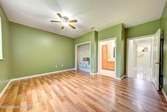 4956 Corfu Dr, Cocoa, FL 32926 - unfurnished bedroom featuring light wood finished floors, baseboards, a closet, and a textured ceiling