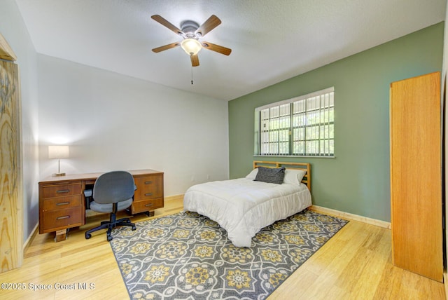 4956 Corfu Dr, Cocoa, FL 32926 - bedroom with light wood-style floors, an office area, baseboards, and ceiling fan