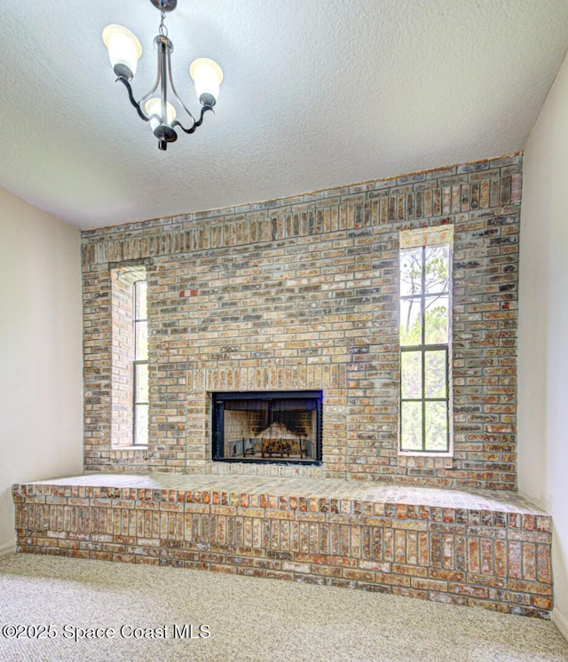 4956 Corfu Dr, Cocoa, FL 32926 - detailed view of carpet, a brick fireplace, a textured ceiling, and baseboards