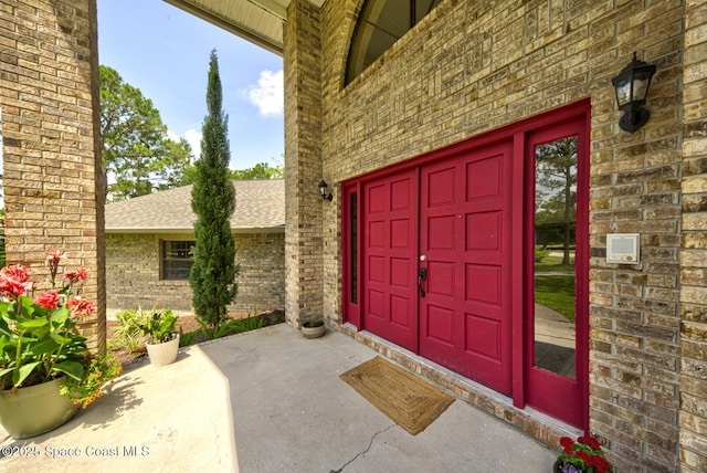 4956 Corfu Dr, Cocoa, FL 32926 - view of exterior entry featuring brick siding and a shingled roof