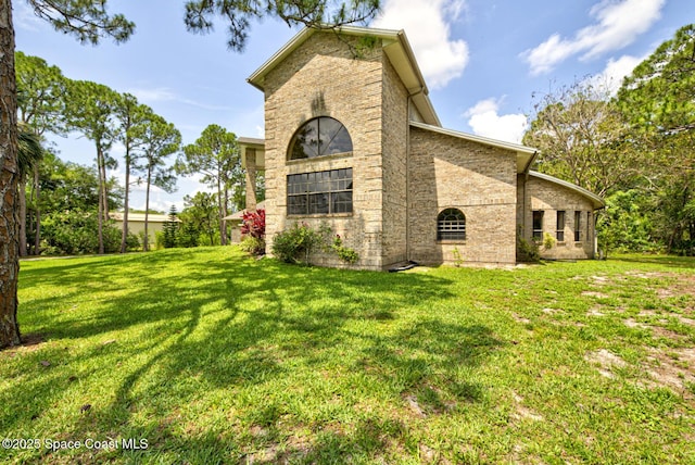 4956 Corfu Dr, Cocoa, FL 32926 - view of side of property featuring brick siding and a lawn