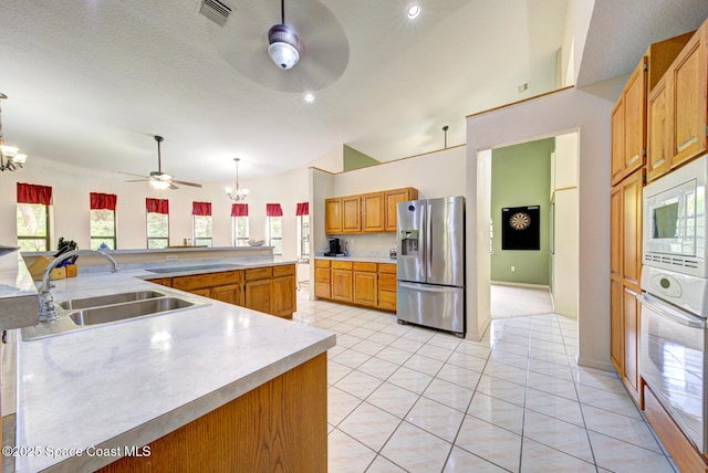 4956 Corfu Dr, Cocoa, FL 32926 - kitchen with stainless steel fridge, ceiling fan, a chandelier, a sink, and wall oven