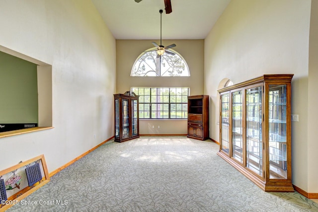 4956 Corfu Dr, Cocoa, FL 32926 - carpeted empty room featuring ceiling fan, a high ceiling, and baseboards