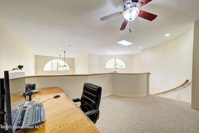 4956 Corfu Dr, Cocoa, FL 32926 - carpeted office space featuring a textured ceiling, ceiling fan, a skylight, and baseboards