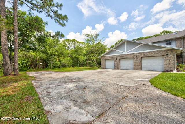 4956 Corfu Dr, Cocoa, FL 32926 - view of property exterior with concrete driveway, brick siding, stucco siding, and an attached garage