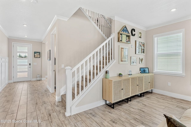 786 Clearwater Ave, Satellite Beach, FL 32937 - entrance foyer featuring crown molding, light wood-type flooring, plenty of natural light, stairway, and recessed lighting