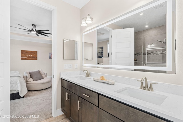 786 Clearwater Ave, Satellite Beach, FL 32937 - ensuite bathroom with double vanity, tiled shower, ceiling fan, and ornamental molding