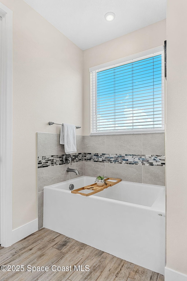 786 Clearwater Ave, Satellite Beach, FL 32937 - full bathroom featuring wood finished floors and a tub to relax in