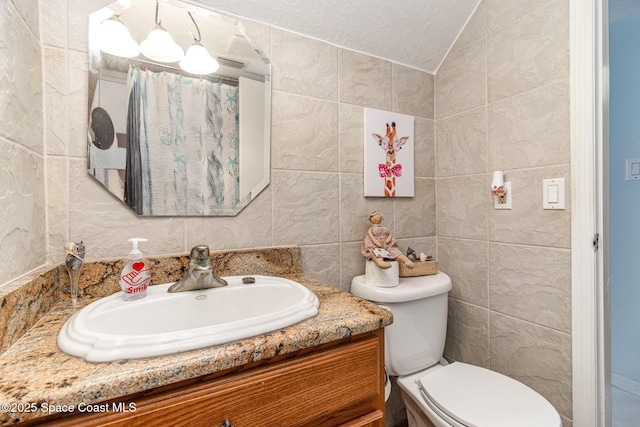 403 Seaport Blvd Unit T145, Cape Canaveral, FL 32920 - bathroom with tile walls, vanity, toilet, and lofted ceiling