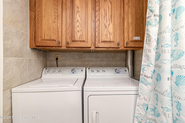 403 Seaport Blvd Unit T145, Cape Canaveral, FL 32920 - laundry area with washing machine and clothes dryer and cabinet space