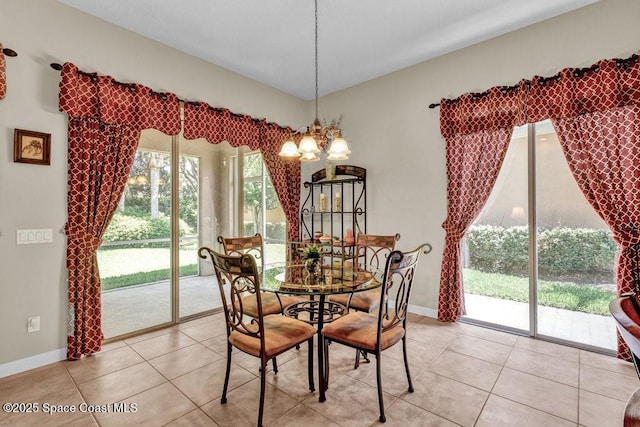5209 Eleuthra Cir, Vero Beach, FL 32967 - dining space with a chandelier, light tile patterned floors, and baseboards