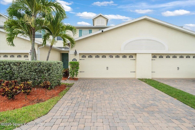 1039 Steven Patrick Ave, Indian Harbour Beach, FL 32937 - view of front of house featuring stucco siding and decorative driveway