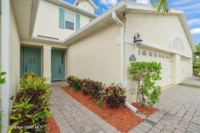 1039 Steven Patrick Ave, Indian Harbour Beach, FL 32937 - doorway to property featuring stucco siding and driveway