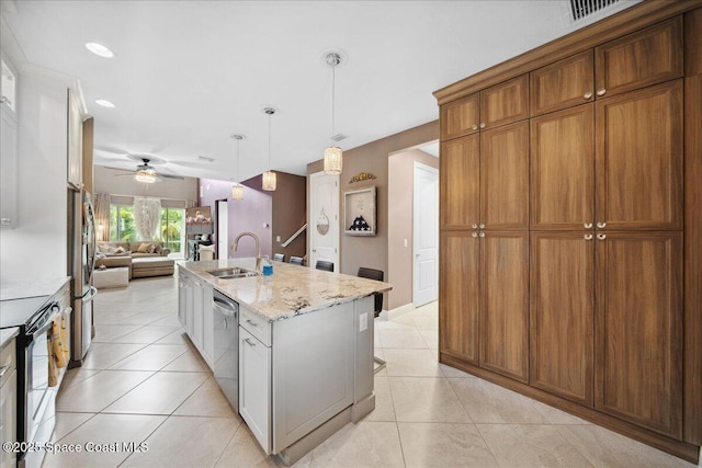1039 Steven Patrick Ave, Indian Harbour Beach, FL 32937 - kitchen with a sink, appliances with stainless steel finishes, open floor plan, light stone counters, and a ceiling fan