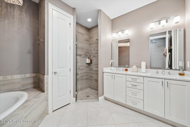 1039 Steven Patrick Ave, Indian Harbour Beach, FL 32937 - bathroom featuring double vanity, a stall shower, tile patterned flooring, a garden tub, and a closet