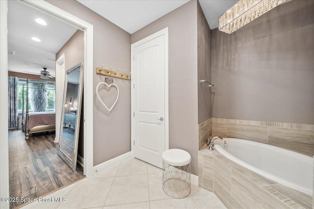 1039 Steven Patrick Ave, Indian Harbour Beach, FL 32937 - ensuite bathroom with a bath, a ceiling fan, baseboards, tile patterned flooring, and recessed lighting