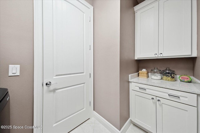1039 Steven Patrick Ave, Indian Harbour Beach, FL 32937 - bar featuring baseboards and light tile patterned floors