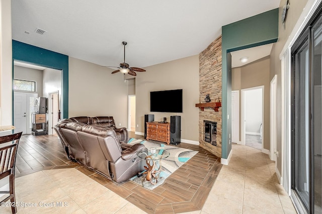 4725 Papaya St, Cocoa, FL 32926 - living room featuring ceiling fan, a stone fireplace, and baseboards