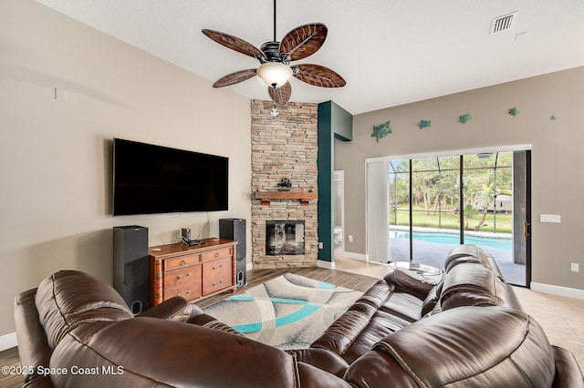 4725 Papaya St, Cocoa, FL 32926 - living area with ceiling fan, baseboards, and a stone fireplace