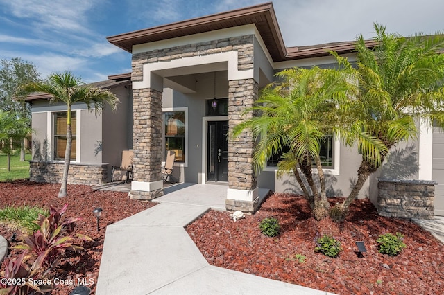 4725 Papaya St, Cocoa, FL 32926 - view of exterior entry with stone siding and stucco siding