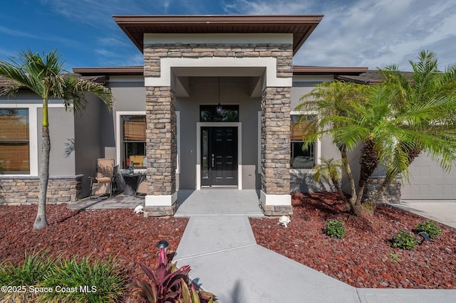 4725 Papaya St, Cocoa, FL 32926 - doorway to property with stone siding, stucco siding, a garage, and concrete driveway
