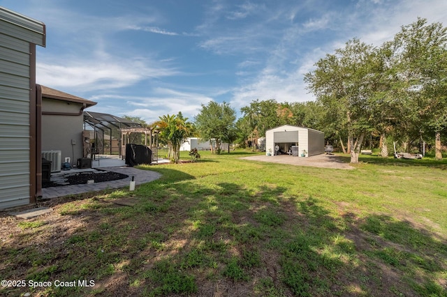 4725 Papaya St, Cocoa, FL 32926 - view of green lawn featuring an outbuilding and a patio