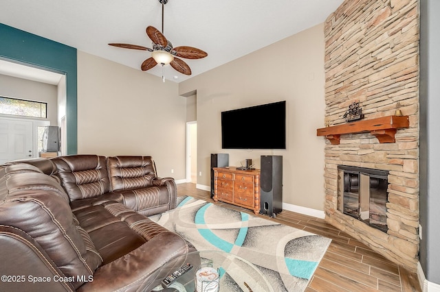 4725 Papaya St, Cocoa, FL 32926 - living area with wood tiled floors, a ceiling fan, baseboards, and a fireplace