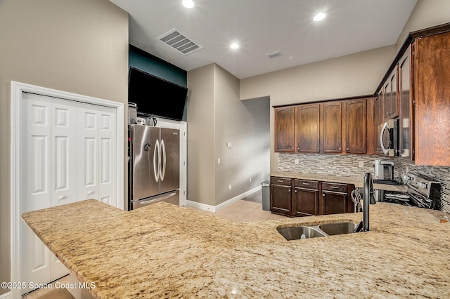4725 Papaya St, Cocoa, FL 32926 - kitchen featuring stainless steel appliances, tasteful backsplash, light tile patterned floors, baseboards, and recessed lighting