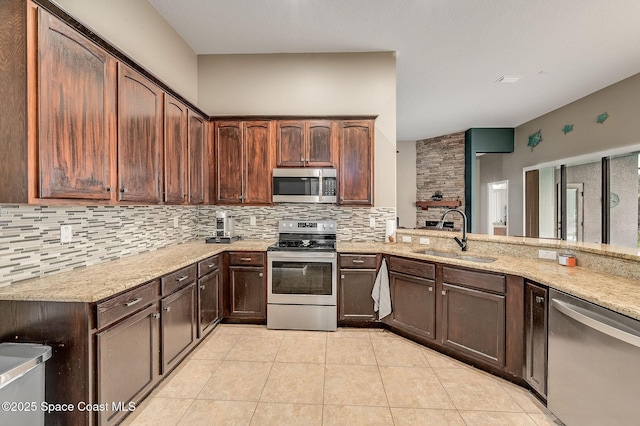 4725 Papaya St, Cocoa, FL 32926 - kitchen with stainless steel appliances, a sink, decorative backsplash, light stone countertops, and light tile patterned floors
