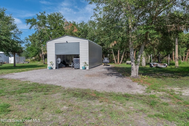 4725 Papaya St, Cocoa, FL 32926 - detached garage featuring gravel driveway