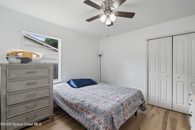822 Lamplighter Dr NW, Palm Bay, FL 32907 - bedroom with light wood-type flooring, a closet, and ceiling fan