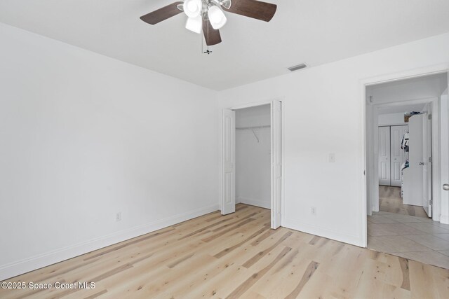 822 Lamplighter Dr NW, Palm Bay, FL 32907 - unfurnished bedroom featuring light wood-style flooring, baseboards, ceiling fan, and a closet