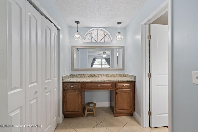 822 Lamplighter Dr NW, Palm Bay, FL 32907 - bathroom with a closet, vanity, tile patterned flooring, ceiling fan, and a textured ceiling
