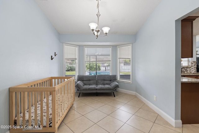 822 Lamplighter Dr NW, Palm Bay, FL 32907 - bedroom with a chandelier, light tile patterned floors, and baseboards