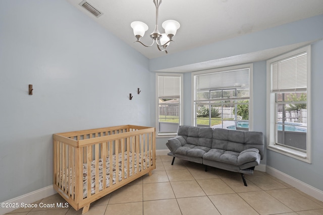 822 Lamplighter Dr NW, Palm Bay, FL 32907 - bedroom featuring a chandelier, light tile patterned flooring, vaulted ceiling, and baseboards