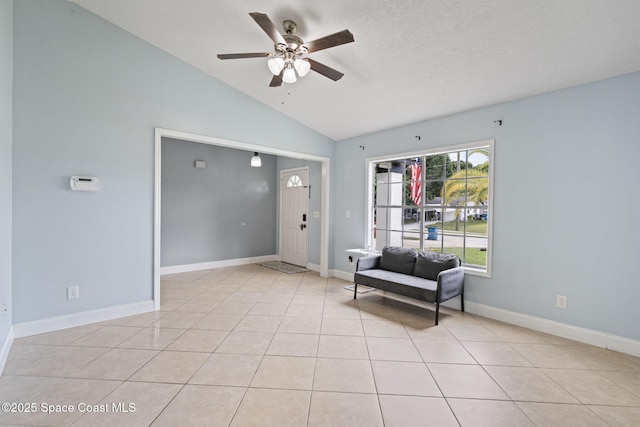 822 Lamplighter Dr NW, Palm Bay, FL 32907 - sitting room with vaulted ceiling, a ceiling fan, light tile patterned flooring, and baseboards