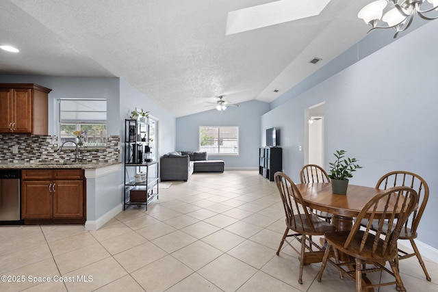 822 Lamplighter Dr NW, Palm Bay, FL 32907 - dining area with a textured ceiling, light tile patterned floors, lofted ceiling, a ceiling fan, and baseboards