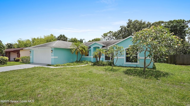 525 Banana Blvd, Merritt Island, FL 32952 - ranch-style house with stucco siding, concrete driveway, and a garage