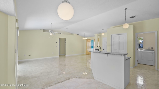 525 Banana Blvd, Merritt Island, FL 32952 - kitchen with independent washer and dryer, light stone countertops, ceiling fan, light tile patterned floors, and lofted ceiling