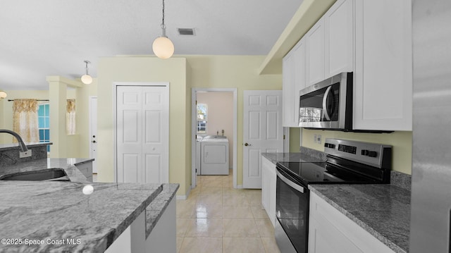 525 Banana Blvd, Merritt Island, FL 32952 - kitchen featuring appliances with stainless steel finishes, a sink, white cabinets, light tile patterned floors, and pendant lighting