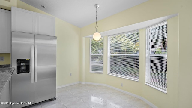 525 Banana Blvd, Merritt Island, FL 32952 - kitchen with stainless steel fridge with ice dispenser, lofted ceiling, decorative light fixtures, light tile patterned floors, and baseboards