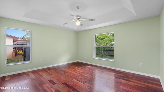 525 Banana Blvd, Merritt Island, FL 32952 - spare room with plenty of natural light, a tray ceiling, and wood-type flooring